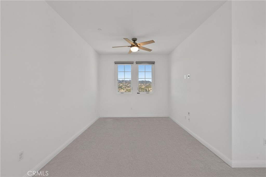 20828 Bur Oak Circle Porter Ranch, CA 91326 - Photo 17 of 43 an empty room with a window and ceiling fan