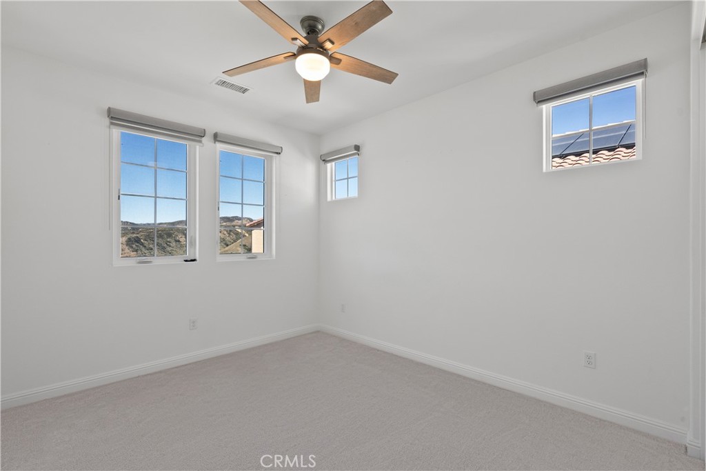 20828 Bur Oak Circle Porter Ranch, CA 91326 - Photo 22 of 43 an empty room with a window and a fan