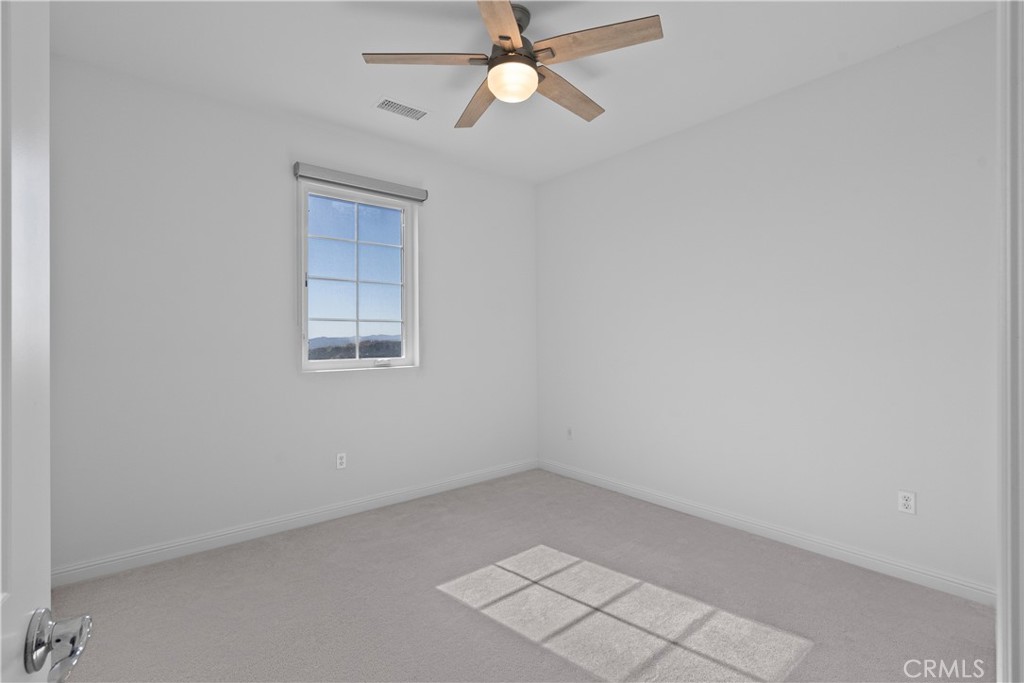 20828 Bur Oak Circle Porter Ranch, CA 91326 - Photo 24 of 43 an empty room with closet and a chandelier fan