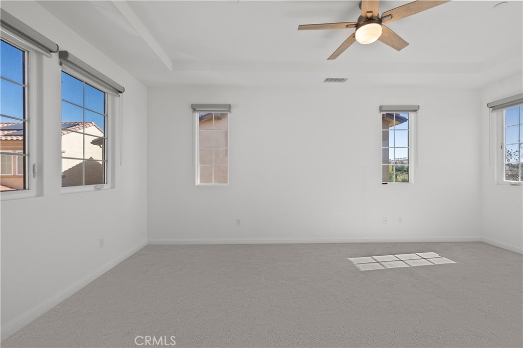 20828 Bur Oak Circle Porter Ranch, CA 91326 - Photo 25 of 43 an empty room with windows and fan