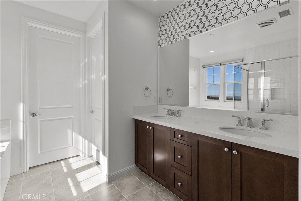 20828 Bur Oak Circle Porter Ranch, CA 91326 - Photo 29 of 43 a spacious bathroom with a double vanity sink and a mirror