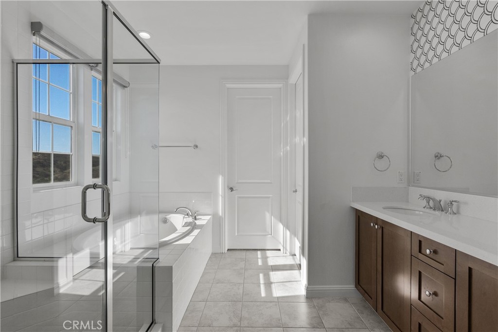 20828 Bur Oak Circle Porter Ranch, CA 91326 - Photo 30 of 43 a bathroom with a tub sink and mirror