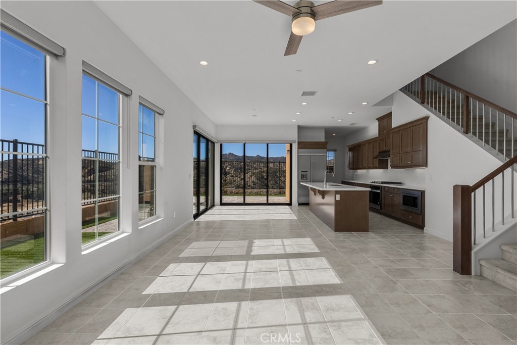20828 Bur Oak Circle Porter Ranch, CA 91326 - Photo 4 of 43 a large white kitchen with stainless steel appliances granite countertop a large window and a counter top space