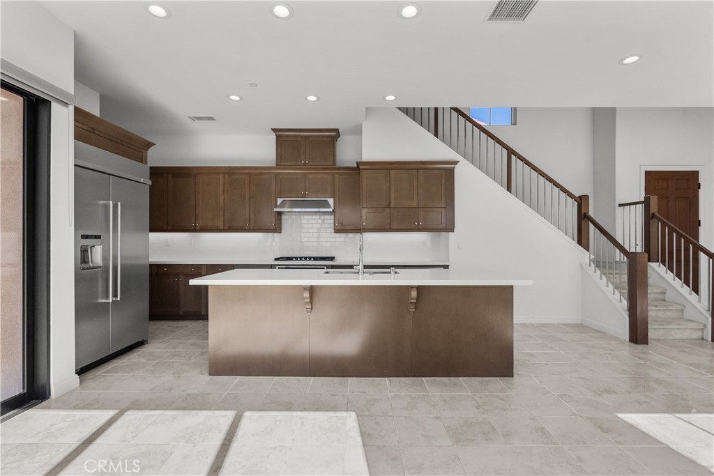 20828 Bur Oak Circle Porter Ranch, CA 91326 - Photo 6 of 43 a view of kitchen with stainless steel appliances kitchen island a sink a refrigerator and chairs