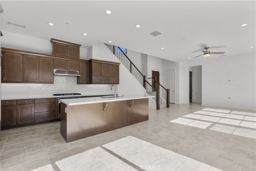 20828 Bur Oak Circle Porter Ranch, CA 91326 - Photo 7 of 43 a kitchen with stainless steel appliances kitchen island a refrigerator sink and cabinets