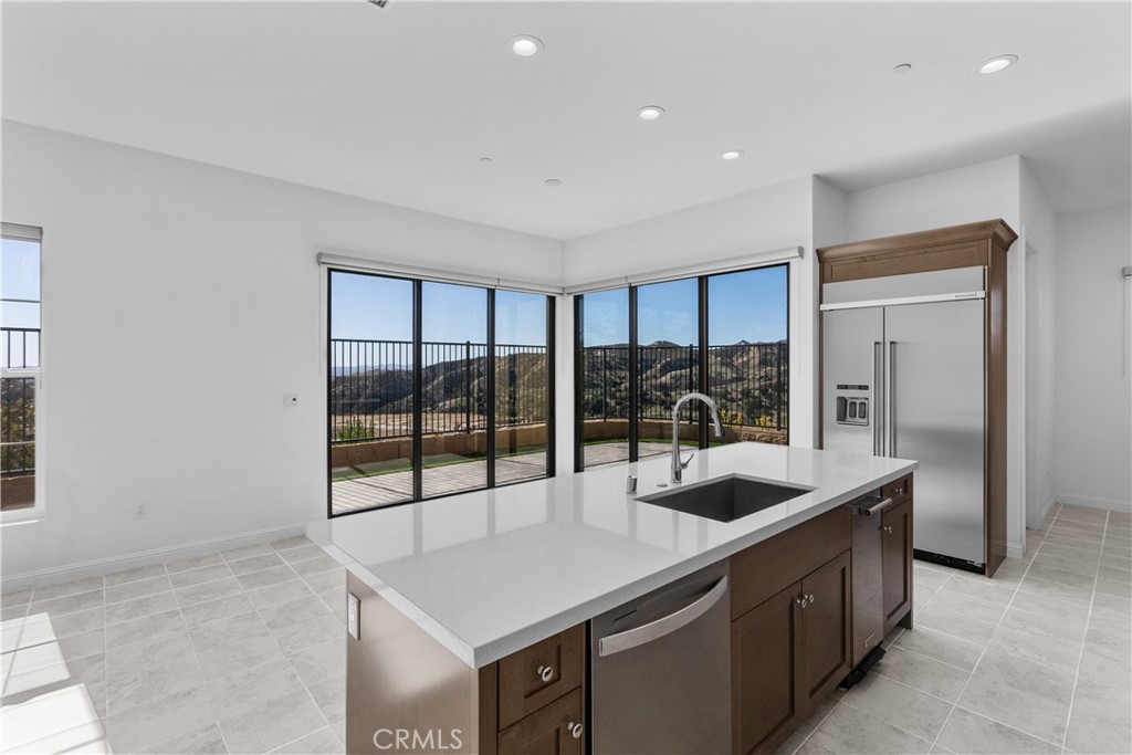 20828 Bur Oak Circle Porter Ranch, CA 91326 - Photo 9 of 43 a kitchen with a sink and large window