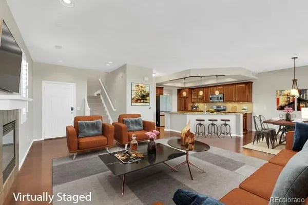 a living room with furniture a fireplace and a flat screen tv