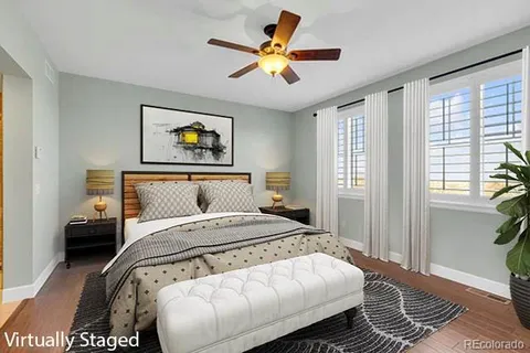 a bedroom with a bed and a painting on the wall