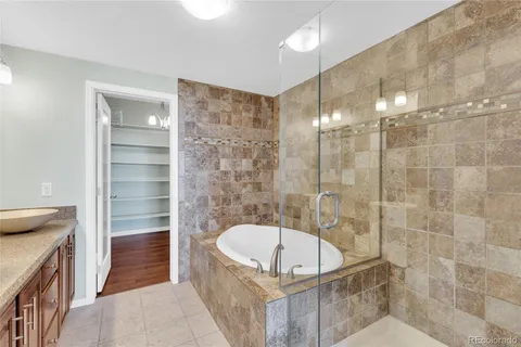 a bathroom with a tub a sink and a shower