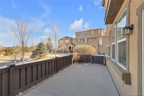 a view of a balcony with wooden fence and floor