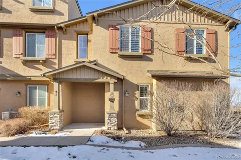 a view of a white house with large windows