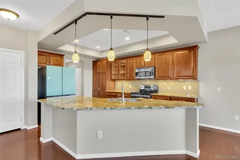 a kitchen with kitchen island a sink a counter space and cabinets