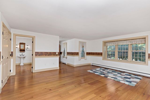 a bathroom with a sink toilet and window