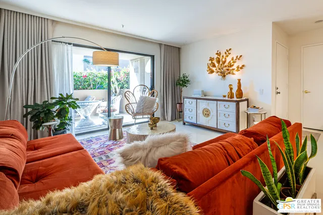 a living room filled with furniture and a large window