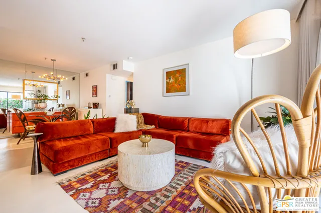 a living room with furniture and a lamp