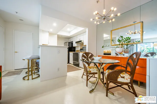 a dining room with furniture and a chandelier