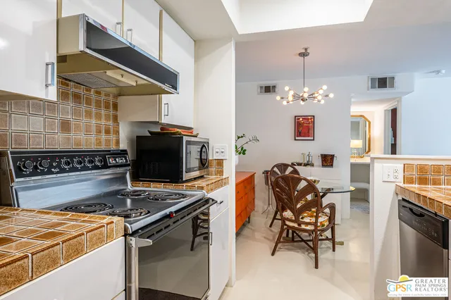 a kitchen with stainless steel appliances granite countertop a stove and a sink