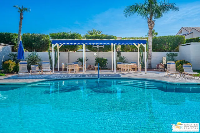 a front view of a house with a yard and potted plants