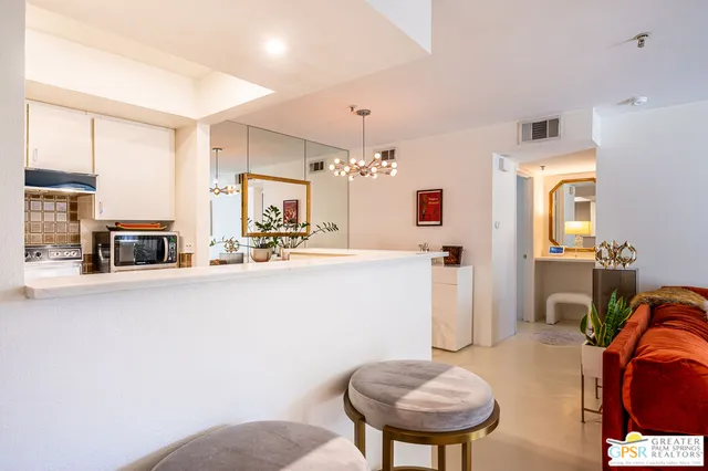 a kitchen with stainless steel appliances granite countertop a sink and a refrigerator
