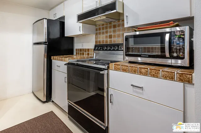 a kitchen with stainless steel appliances and cabinets
