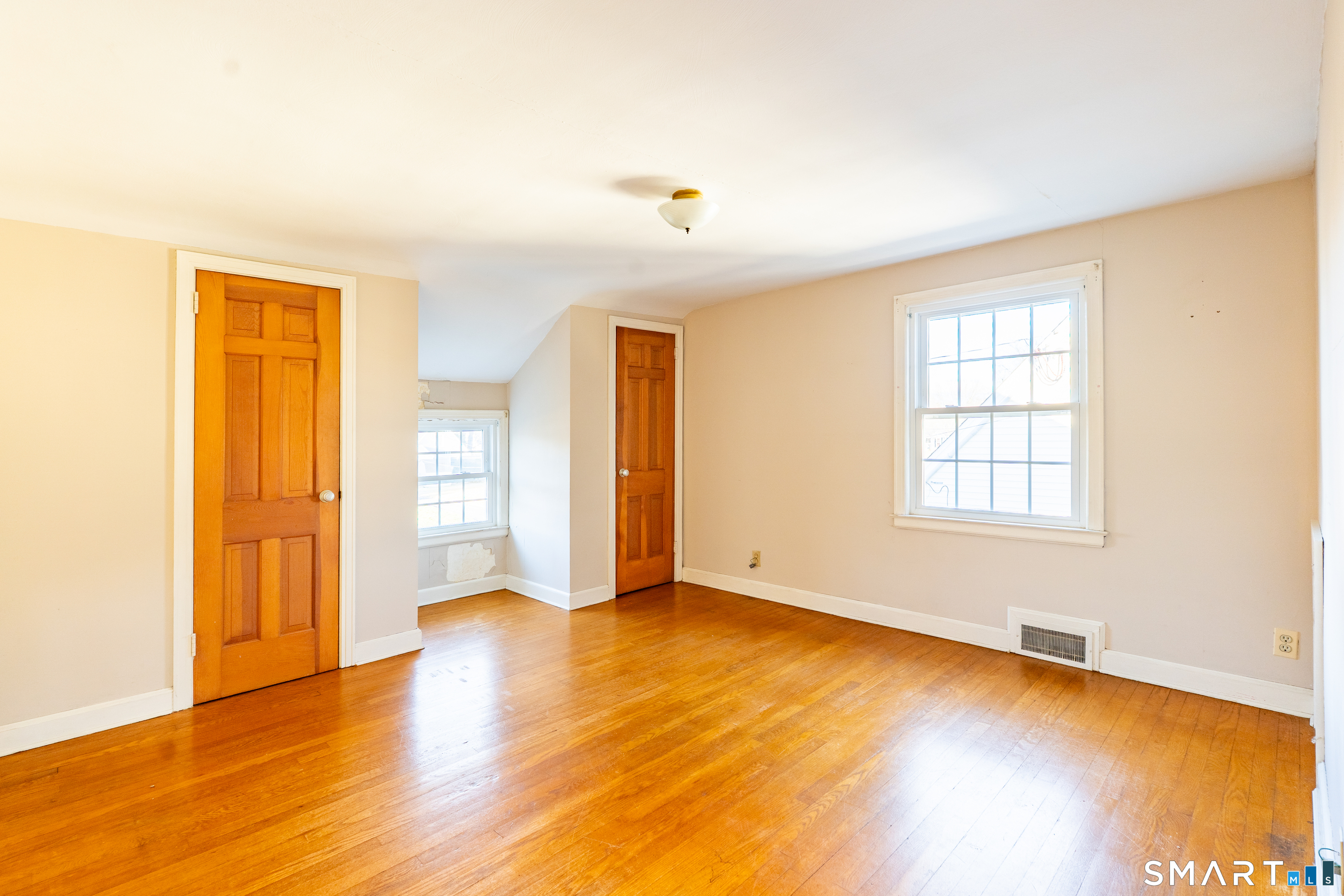 38 Wheeler Road Wethersfield, CT 06109 - Photo 19 of 28 a view of an empty room with window and wooden floor