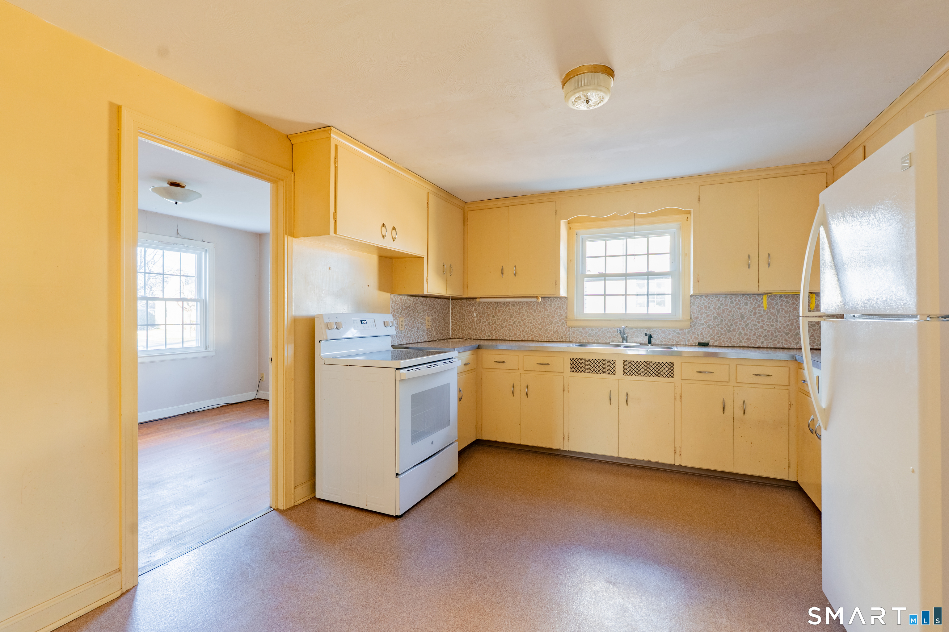 38 Wheeler Road Wethersfield, CT 06109 - Photo 2 of 28 a kitchen with granite countertop white cabinets and white stainless steel appliances