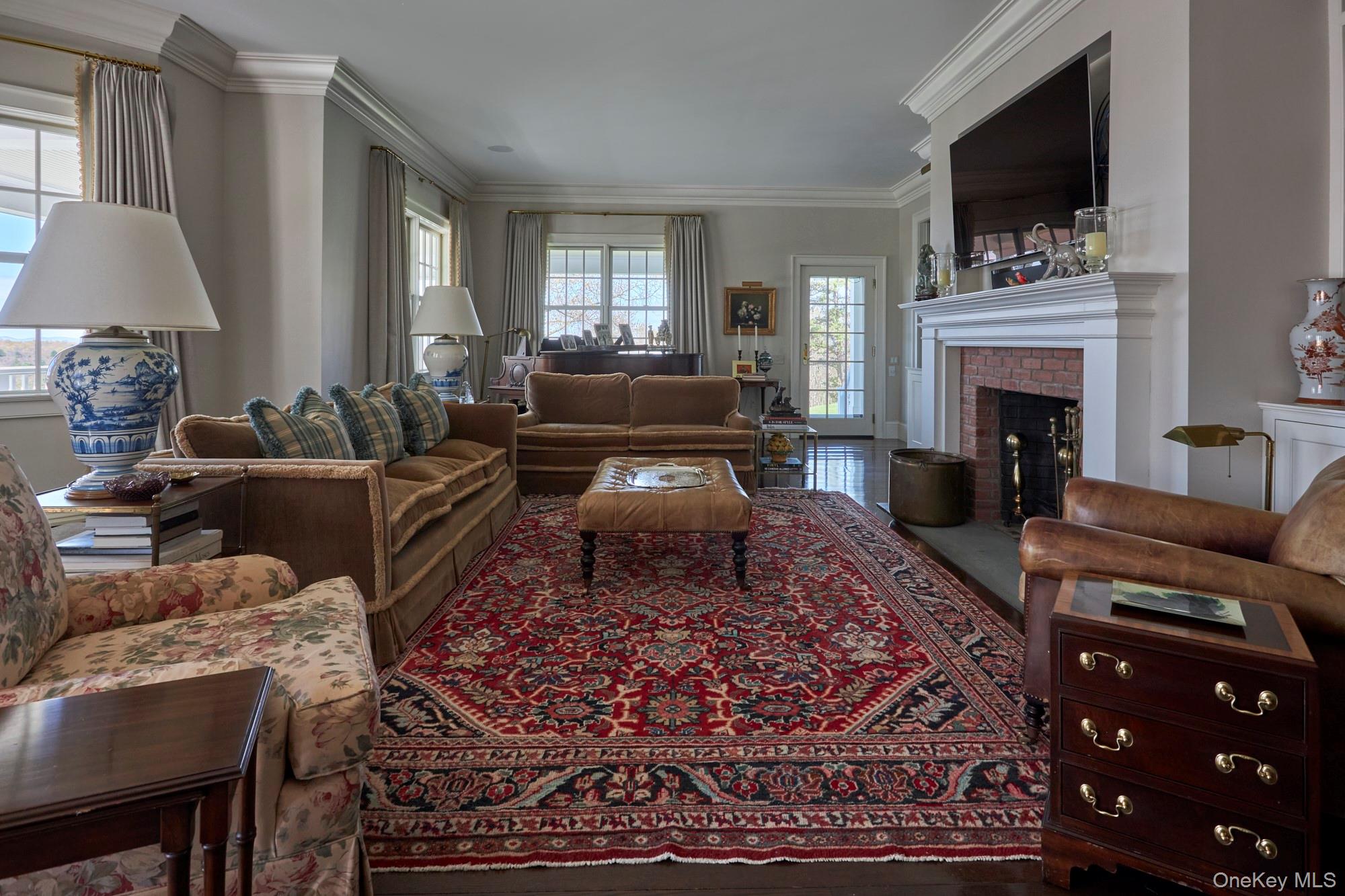 790 Stanford Road Millbrook, NY 12545 - Photo 15 of 50 a living room with furniture a flat screen tv and a fireplace