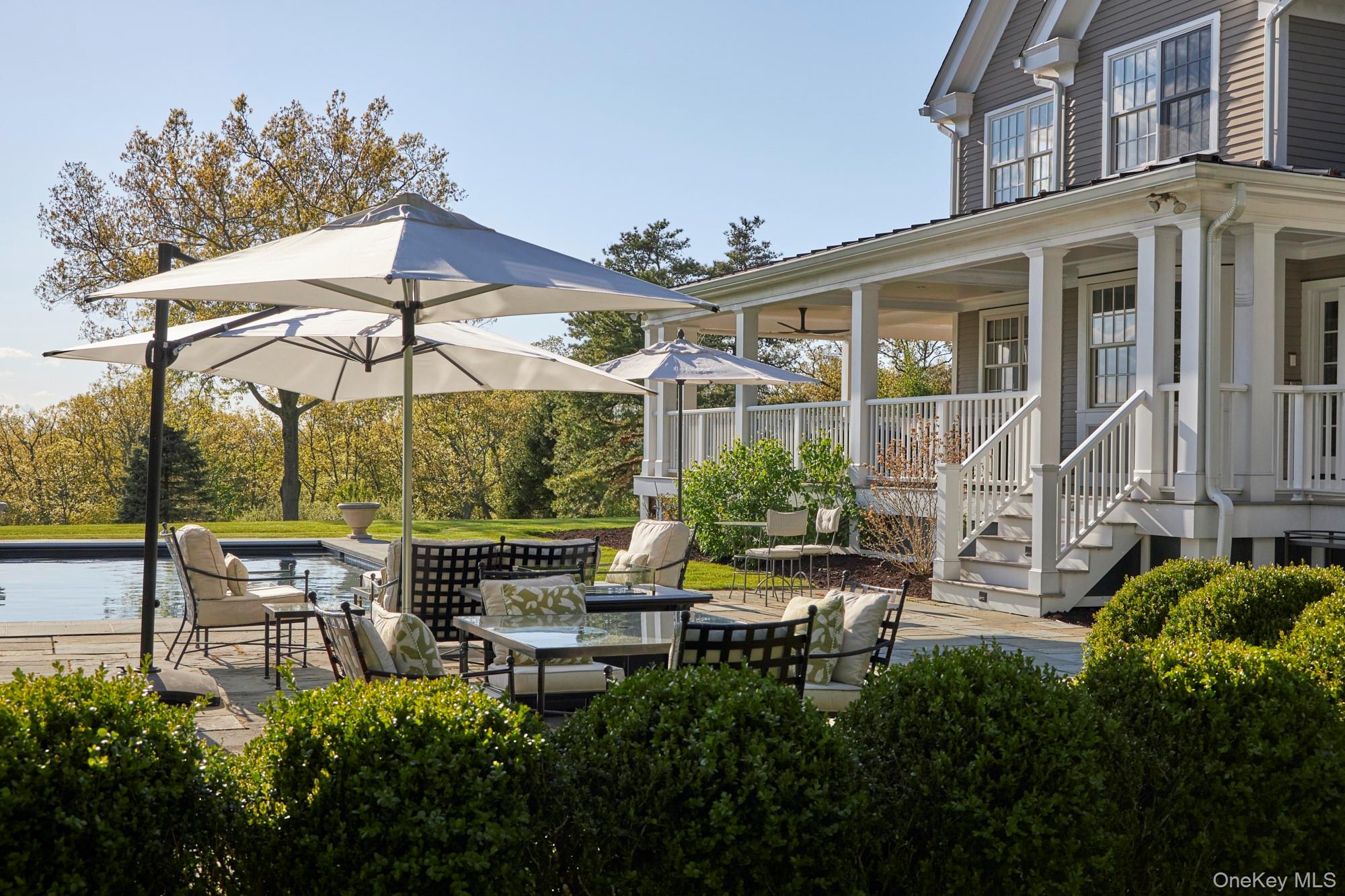 790 Stanford Road Millbrook, NY 12545 - Photo 45 of 50 a view of a patio with table and chairs under an umbrella