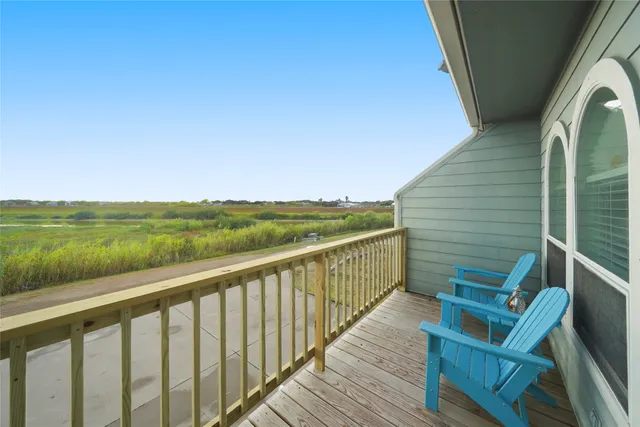 a view of a balcony with wooden floor and outdoor space