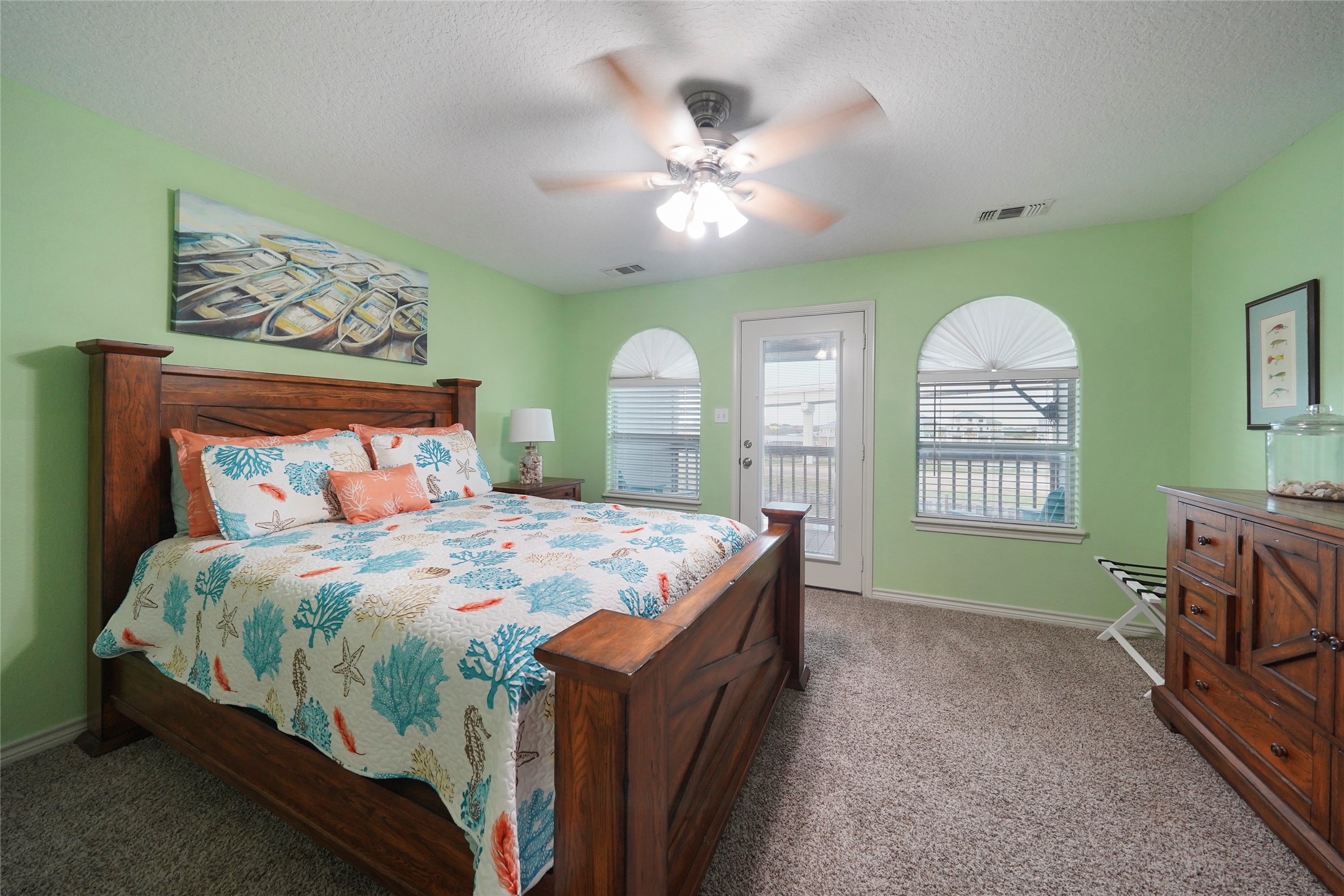 143 Boat Slip Road Matagorda, TX 77457 - Photo 23 of 31 a bedroom with a bed and a chandelier