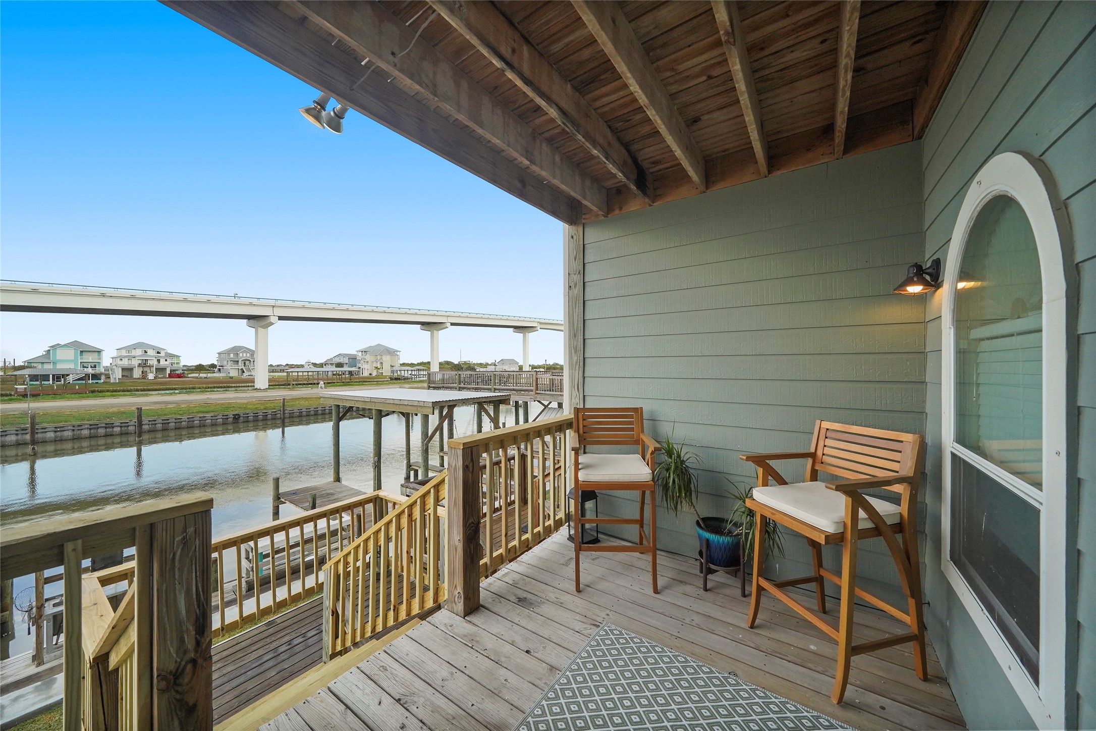 143 Boat Slip Road Matagorda, TX 77457 - Photo 7 of 31 a balcony with wooden floor table and chairs
