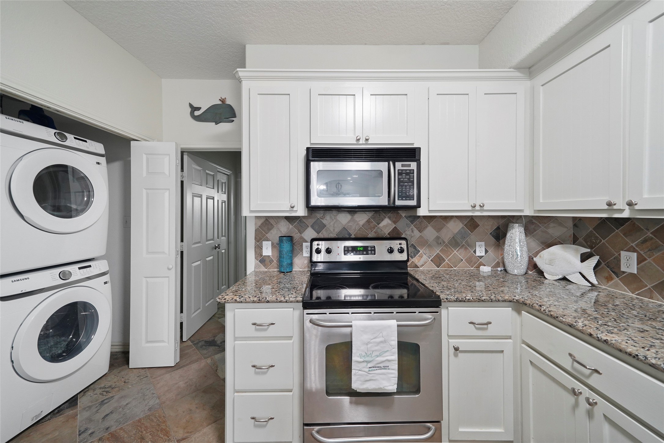 143 Boat Slip Road Matagorda, TX 77457 - Photo 10 of 31 a kitchen with white cabinets stainless steel appliances and sink
