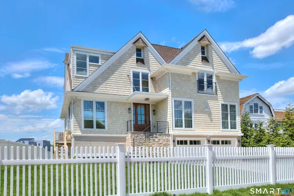a front view of a house with a fence