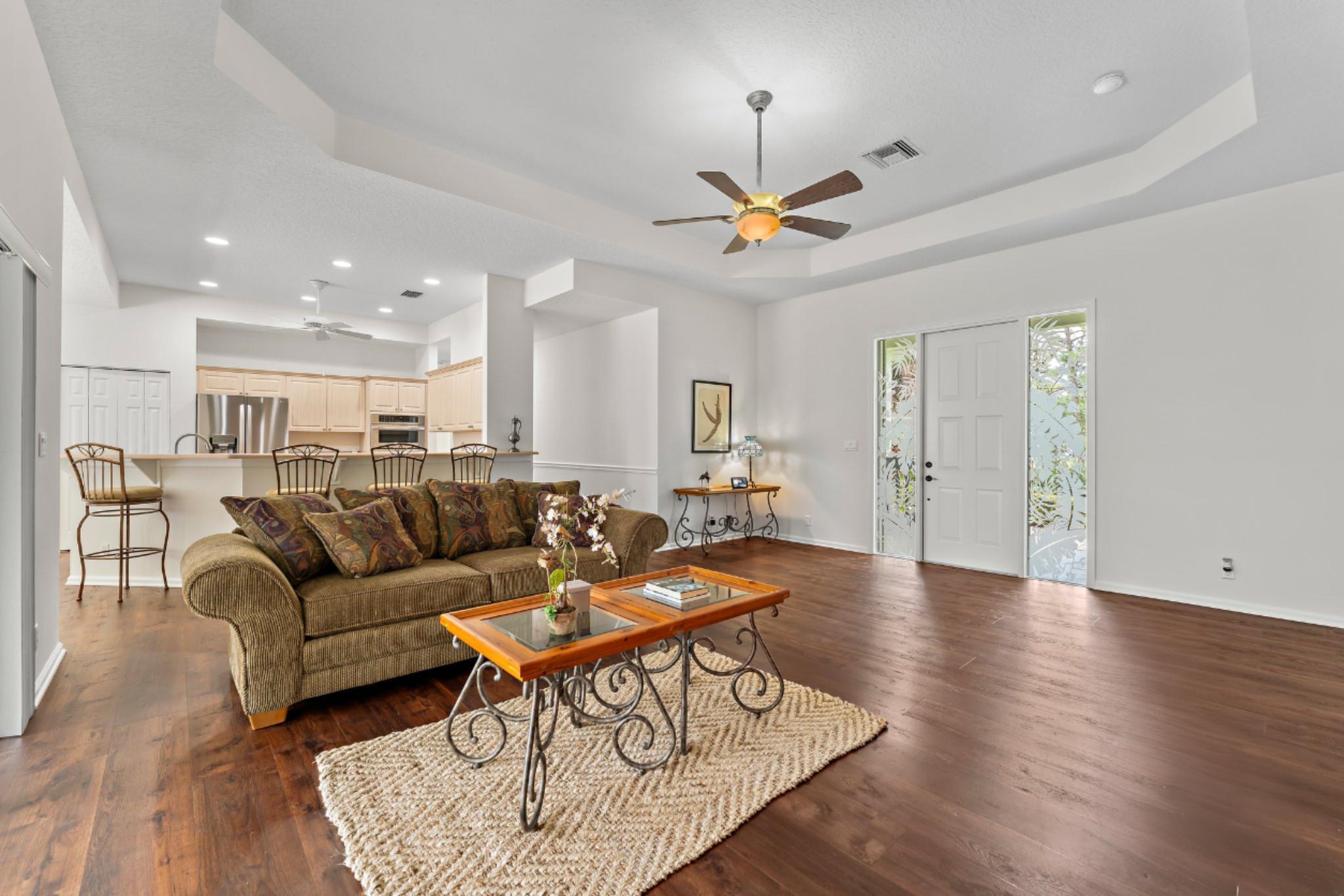 15784 Alexander Run Jupiter, FL 33478 - Photo 10 of 44 a living room with furniture a ceiling fan and a rug