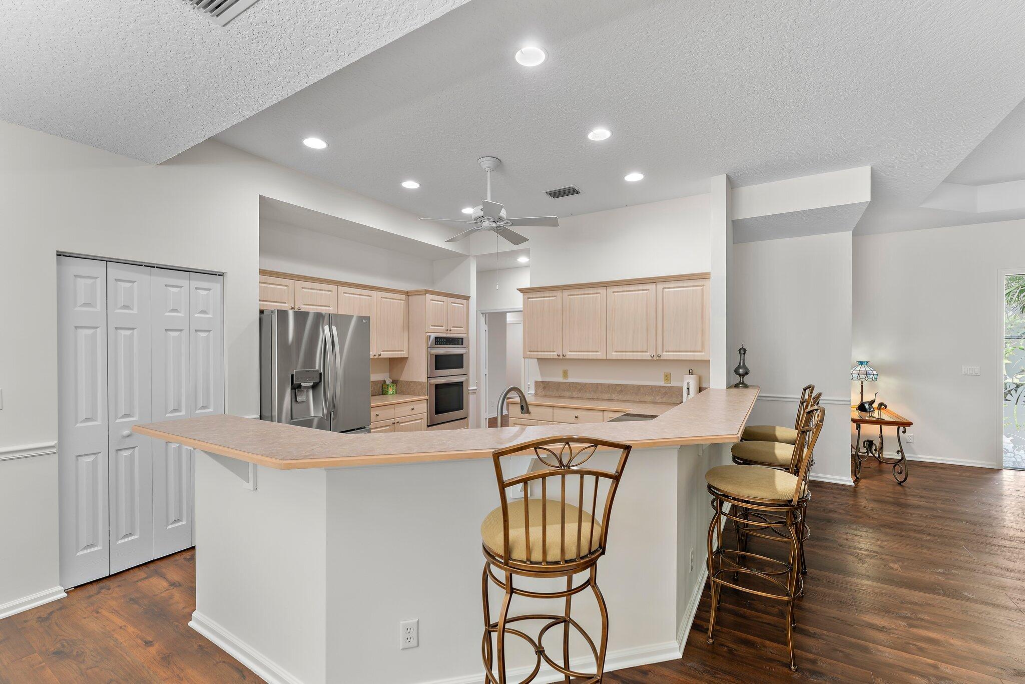 15784 Alexander Run Jupiter, FL 33478 - Photo 15 of 44 a kitchen with stainless steel appliances kitchen island granite countertop a sink and cabinets