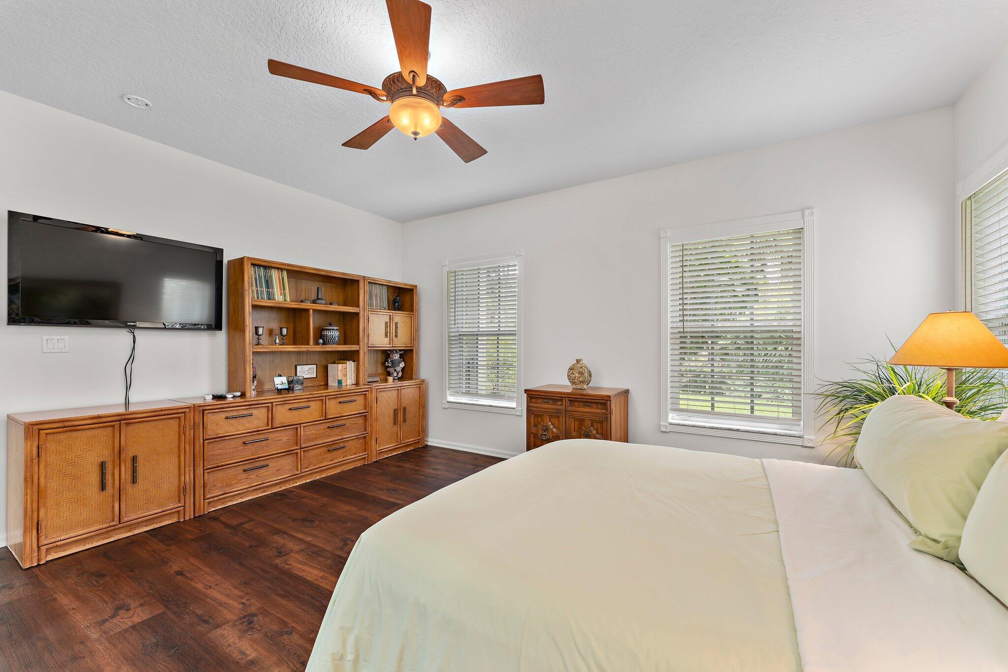 15784 Alexander Run Jupiter, FL 33478 - Photo 18 of 44 a bedroom with furniture and a flat screen tv
