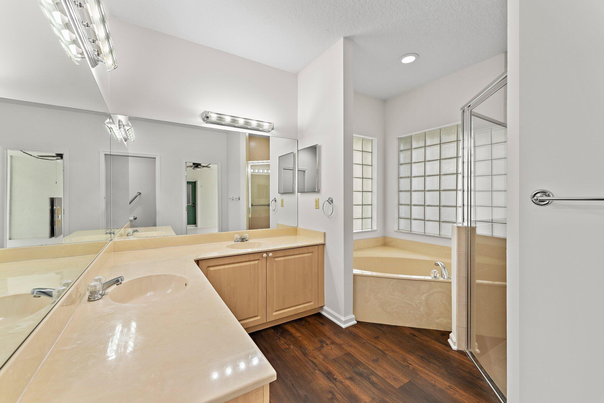 15784 Alexander Run Jupiter, FL 33478 - Photo 20 of 44 a spacious bathroom with a tub sink shower and mirror