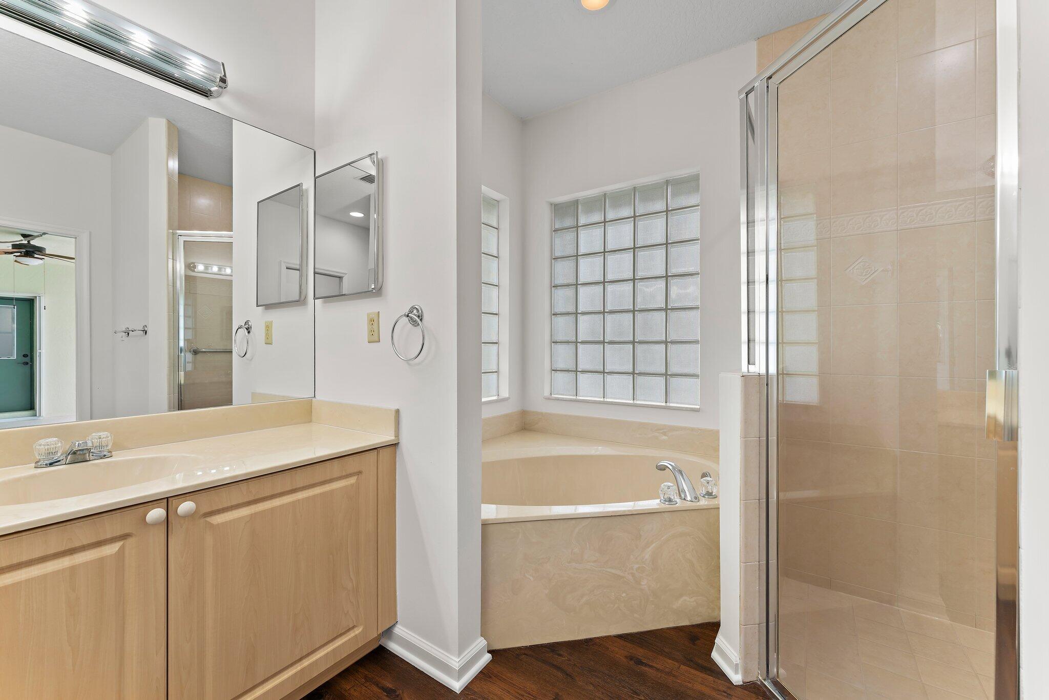 15784 Alexander Run Jupiter, FL 33478 - Photo 21 of 44 a bathroom with a granite countertop sink mirror bathtub and shower