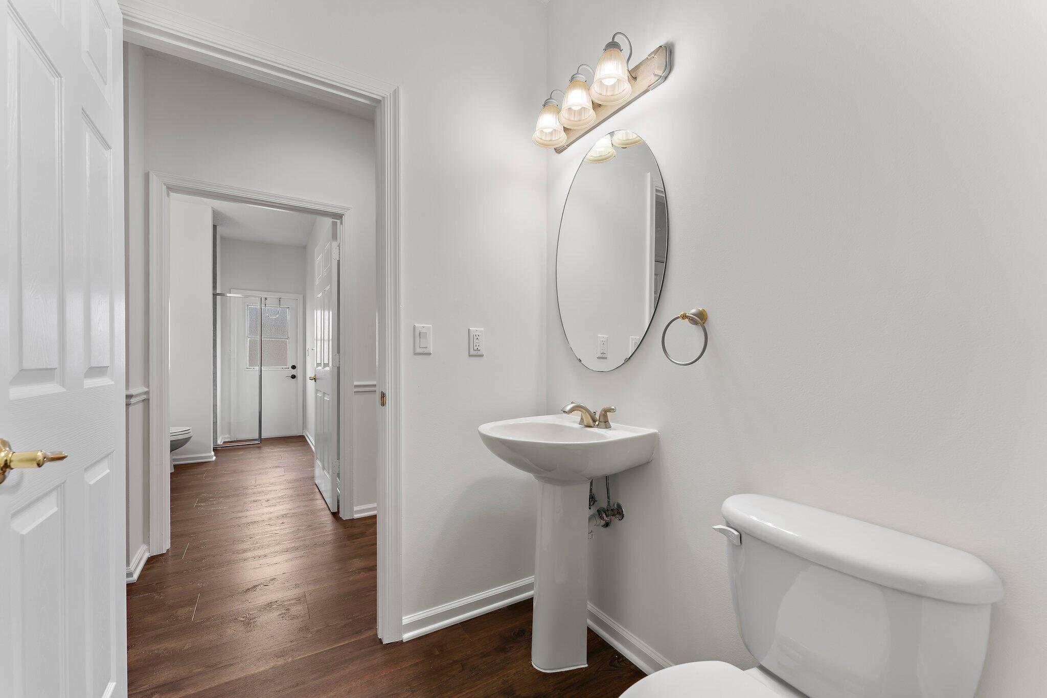 15784 Alexander Run Jupiter, FL 33478 - Photo 25 of 44 a view of a hallway with wooden floor and mirror