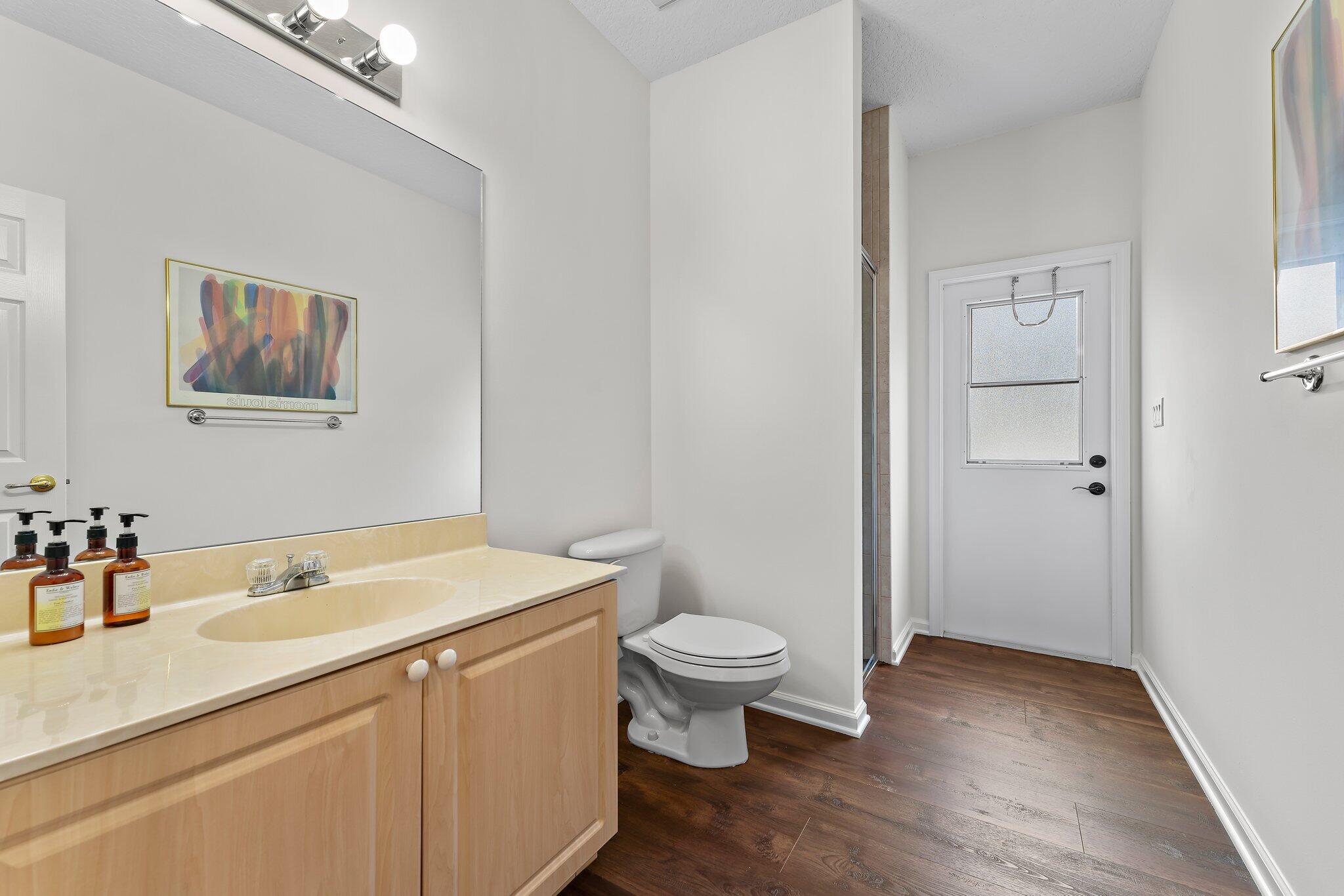 15784 Alexander Run Jupiter, FL 33478 - Photo 29 of 44 a bathroom with a sink toilet and vanity