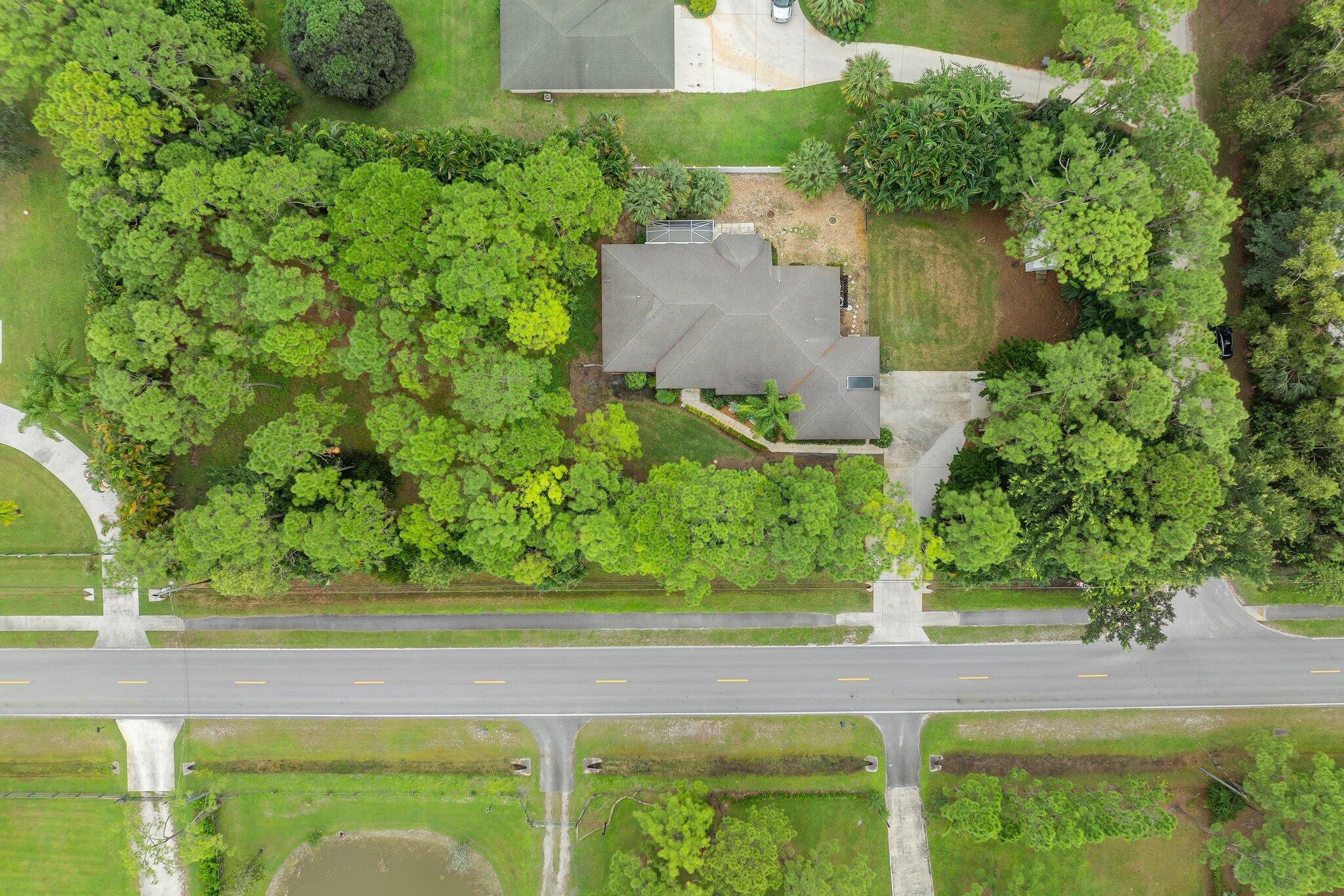 15784 Alexander Run Jupiter, FL 33478 - Photo 39 of 44 an aerial view of a house with a yard and lake view