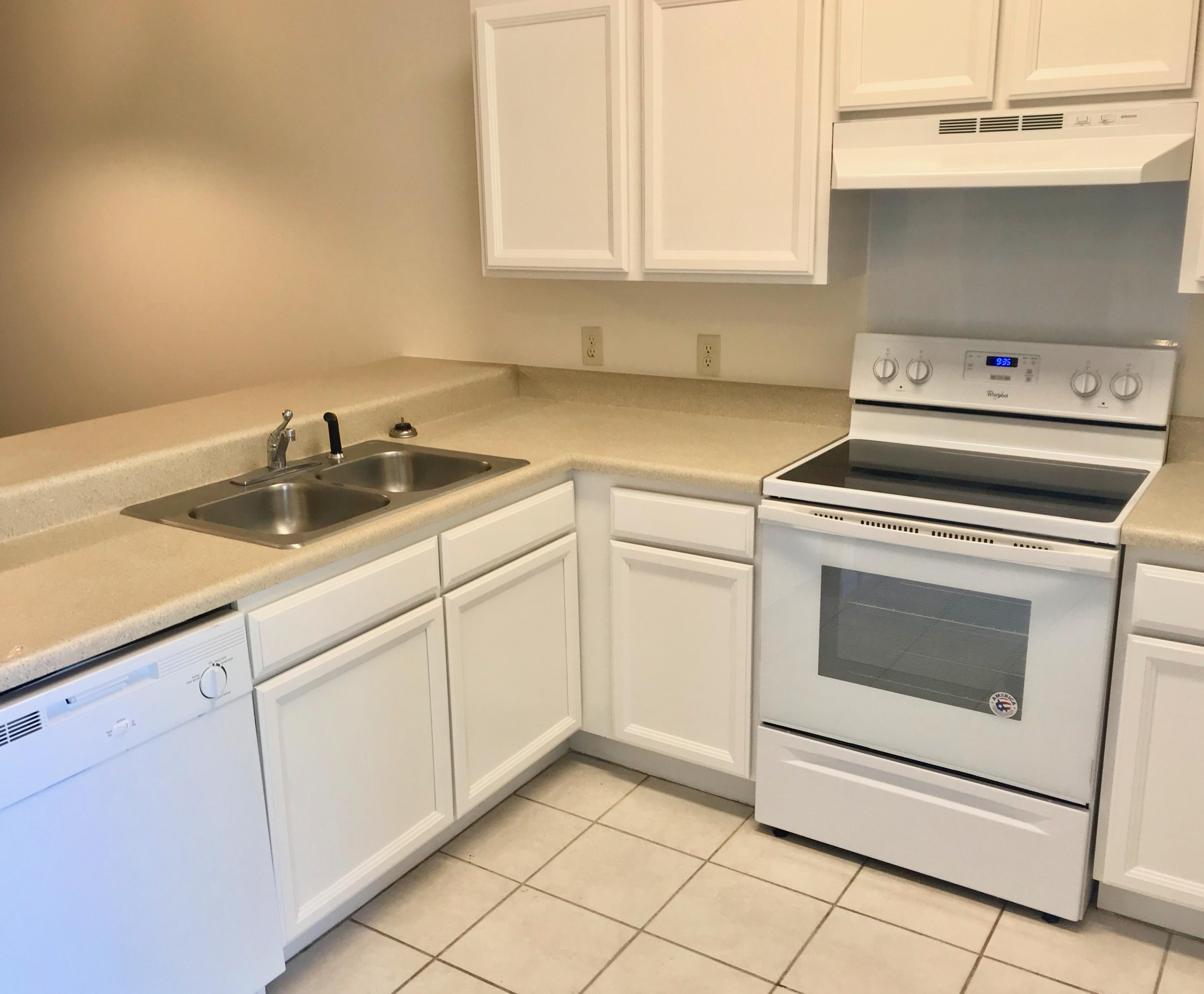 34 Heron's Watch Way, Unit 3203 Santa Rosa Beach, FL 32459 - Photo 2 of 12 a kitchen with white cabinets appliances and sink