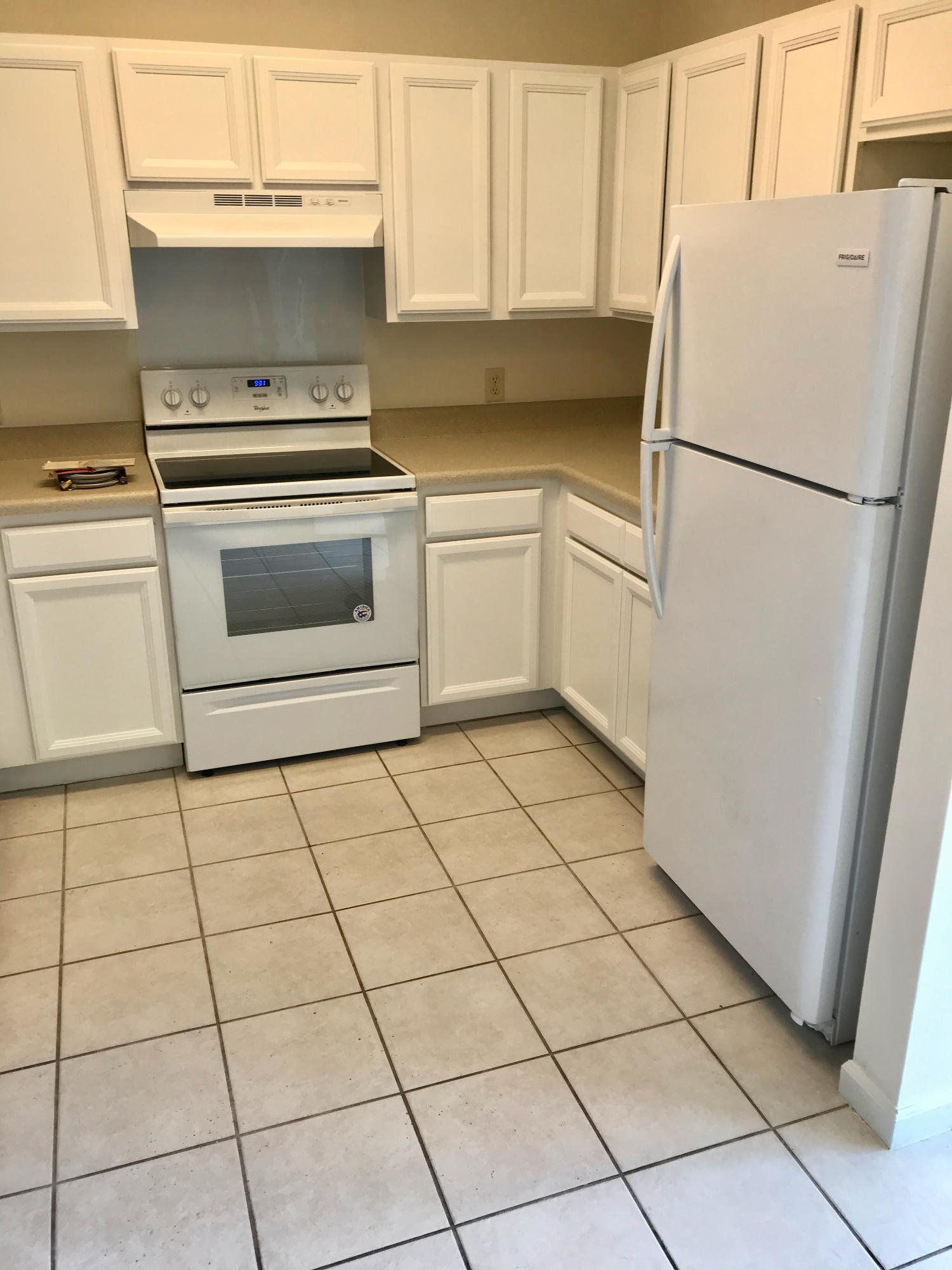 34 Heron's Watch Way, Unit 3203 Santa Rosa Beach, FL 32459 - Photo 3 of 12 a white refrigerator freezer and a stove sitting inside of a kitchen
