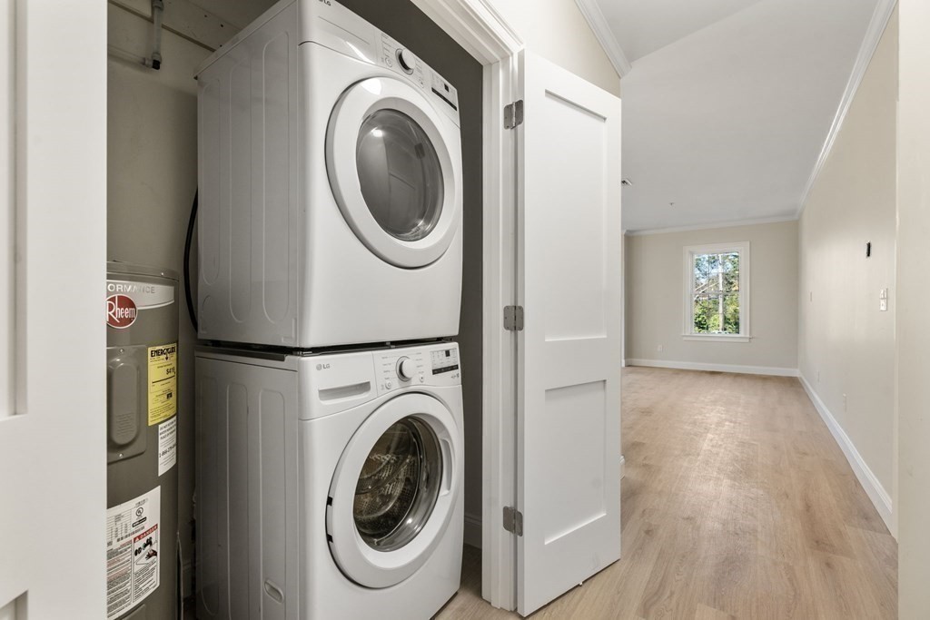 242 Main Street, Unit 203 Millis, MA 02054 - Photo 13 of 18 a view of a hallway with washer and dryer