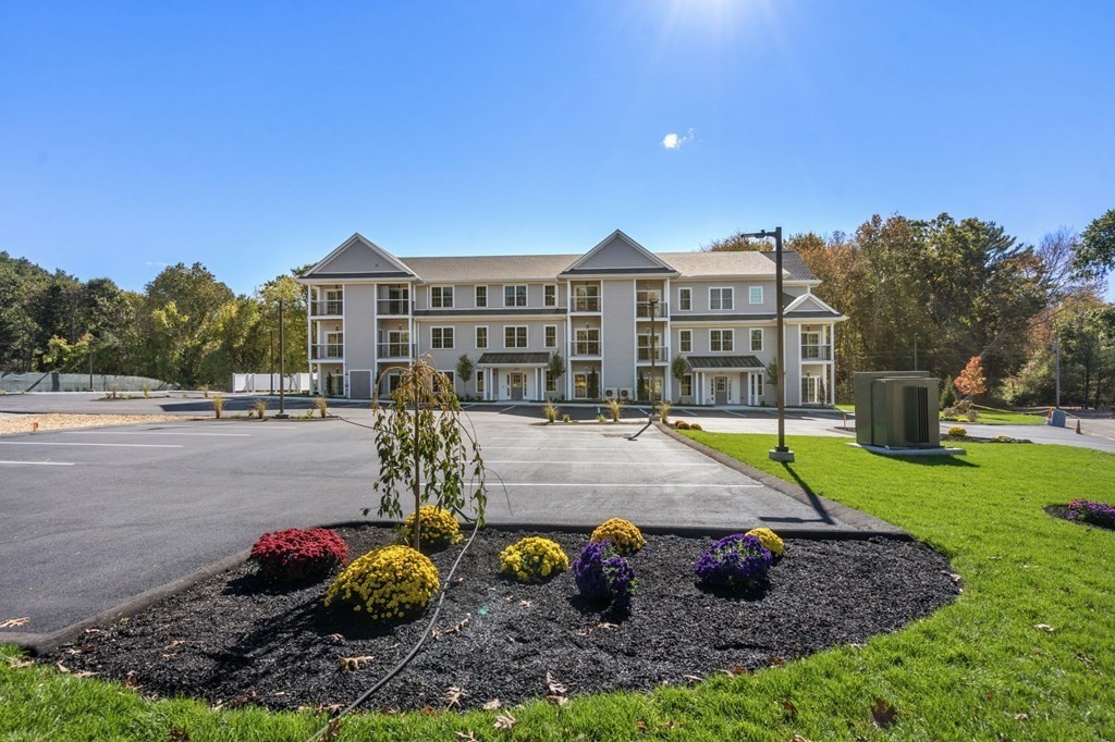 242 Main Street, Unit 203 Millis, MA 02054 - Photo 2 of 18 a view of a house with a swimming pool