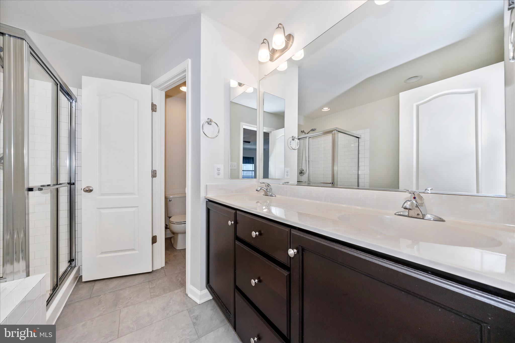 203 Charterhouse Street Falling Waters, WV 25419 - Photo 25 of 46 a bathroom with a double vanity sink a mirror and a shower