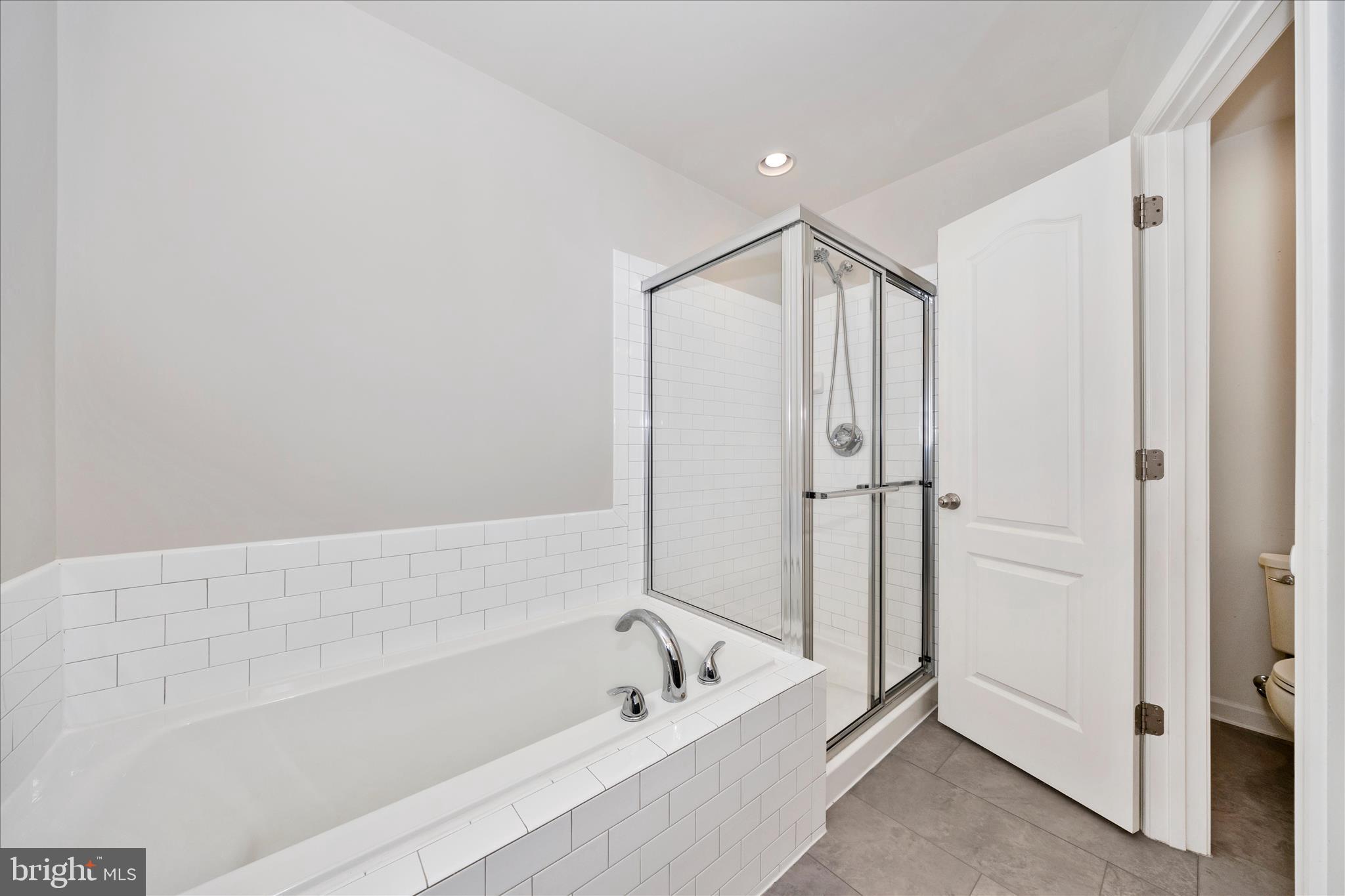 203 Charterhouse Street Falling Waters, WV 25419 - Photo 26 of 46 a bathroom with a bathtub and a shower
