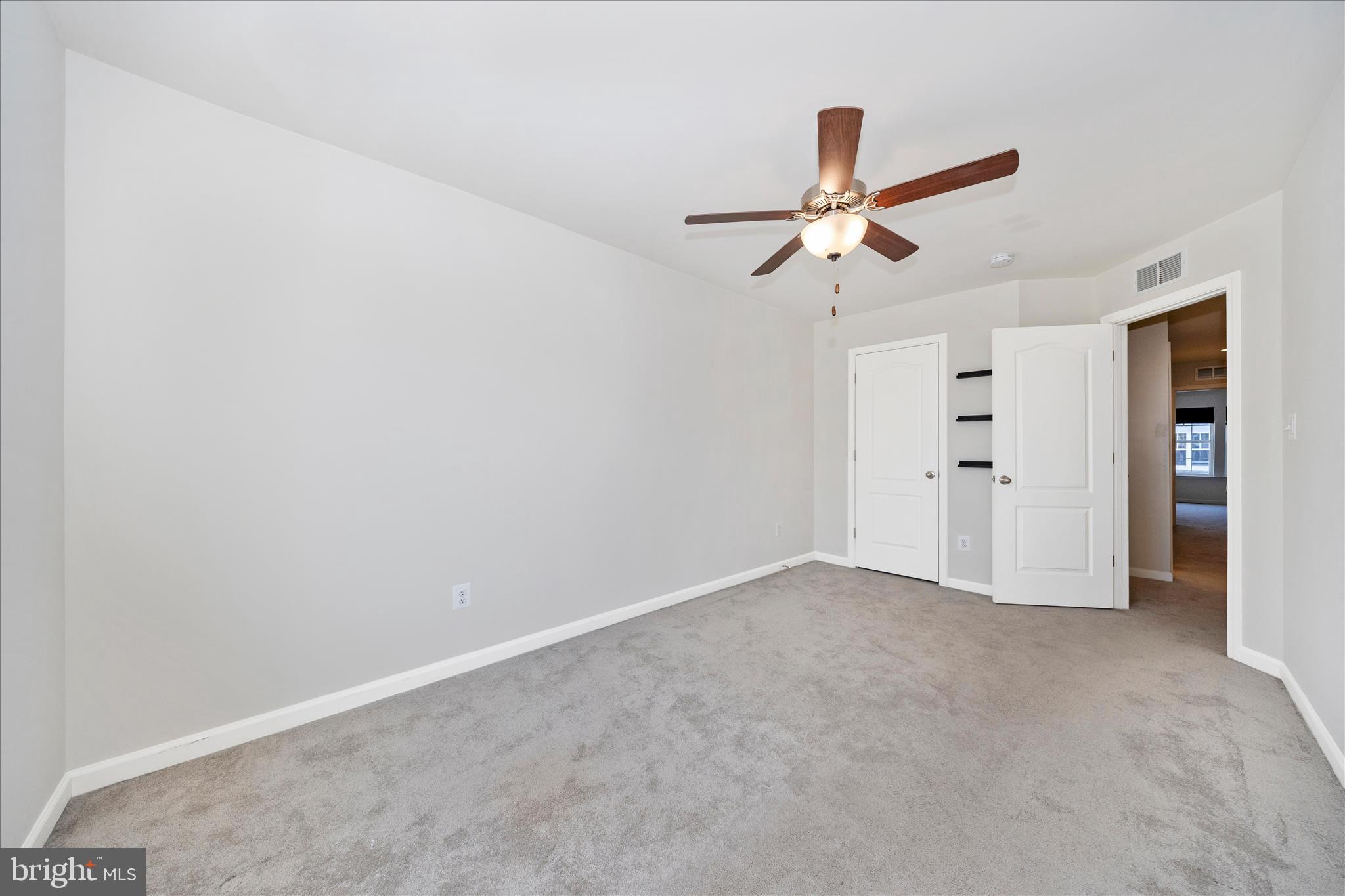 203 Charterhouse Street Falling Waters, WV 25419 - Photo 32 of 46 an empty room with closet and a ceiling fan