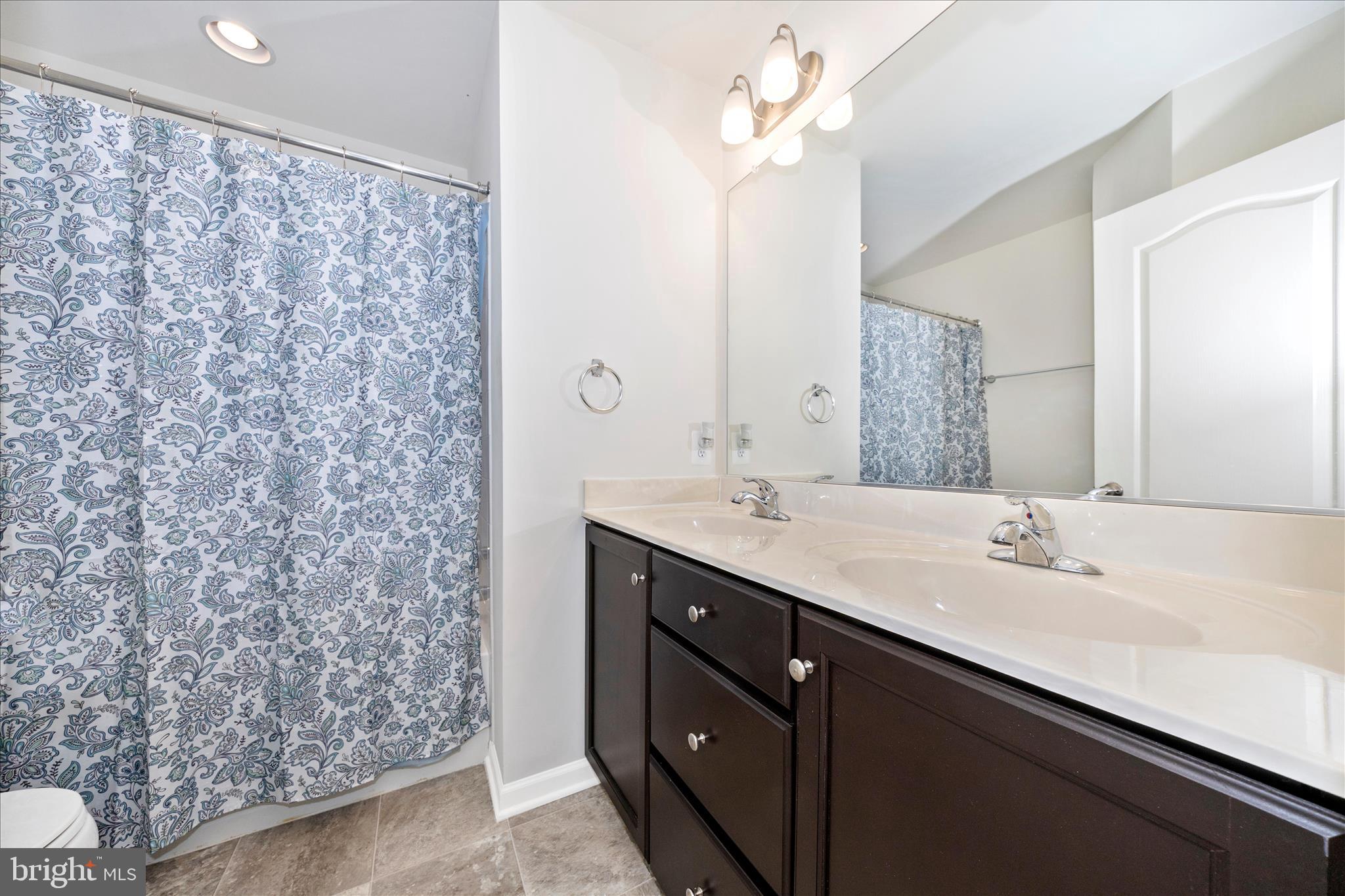 203 Charterhouse Street Falling Waters, WV 25419 - Photo 33 of 46 a bathroom with a double vanity sink mirror and shower
