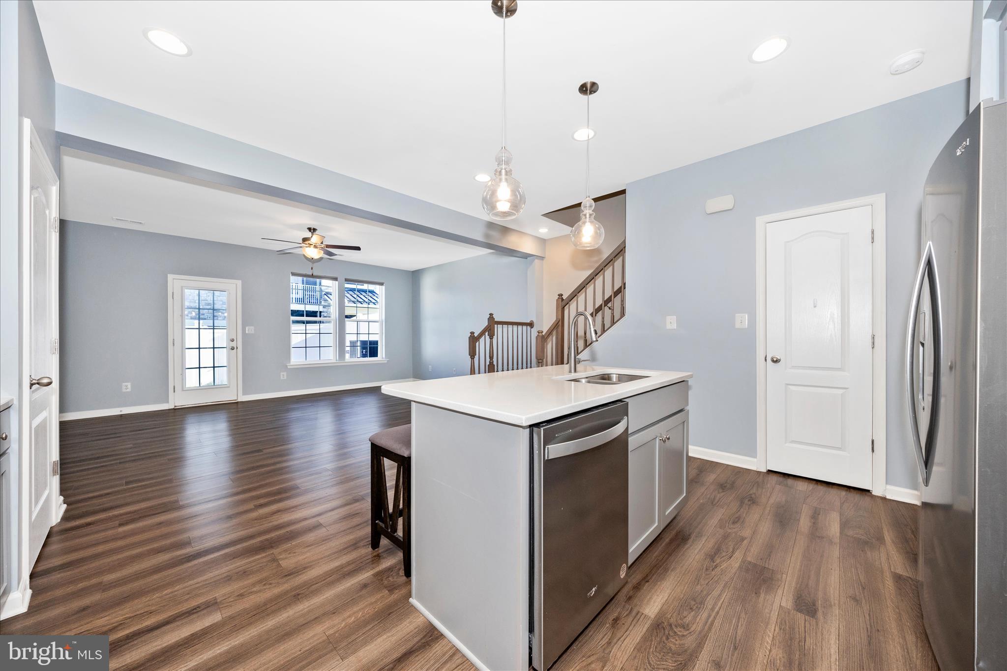203 Charterhouse Street Falling Waters, WV 25419 - Photo 5 of 46 a kitchen that has a stove and a wooden floor